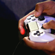 Hands holding a PlayStation 4 Controller.